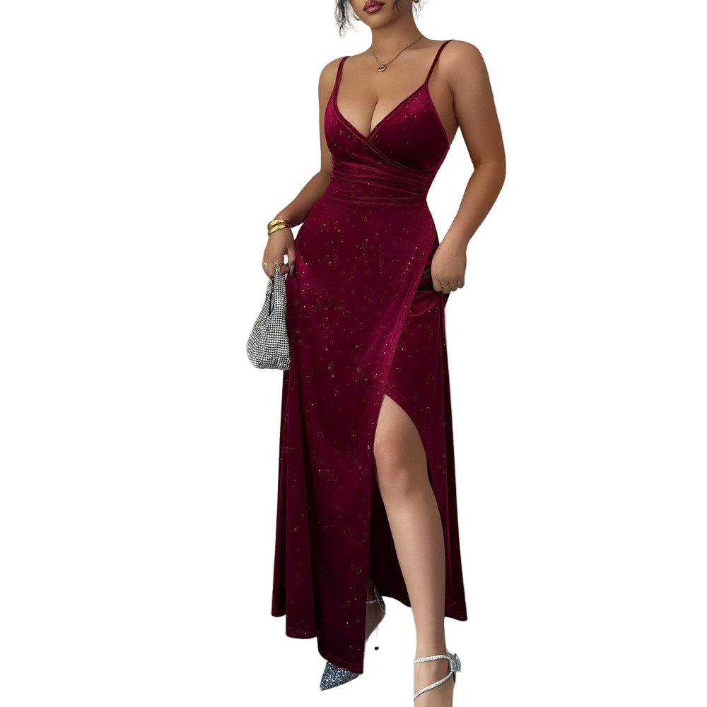 Woman in a burgundy evening gown with a slit, standing against a plain background.